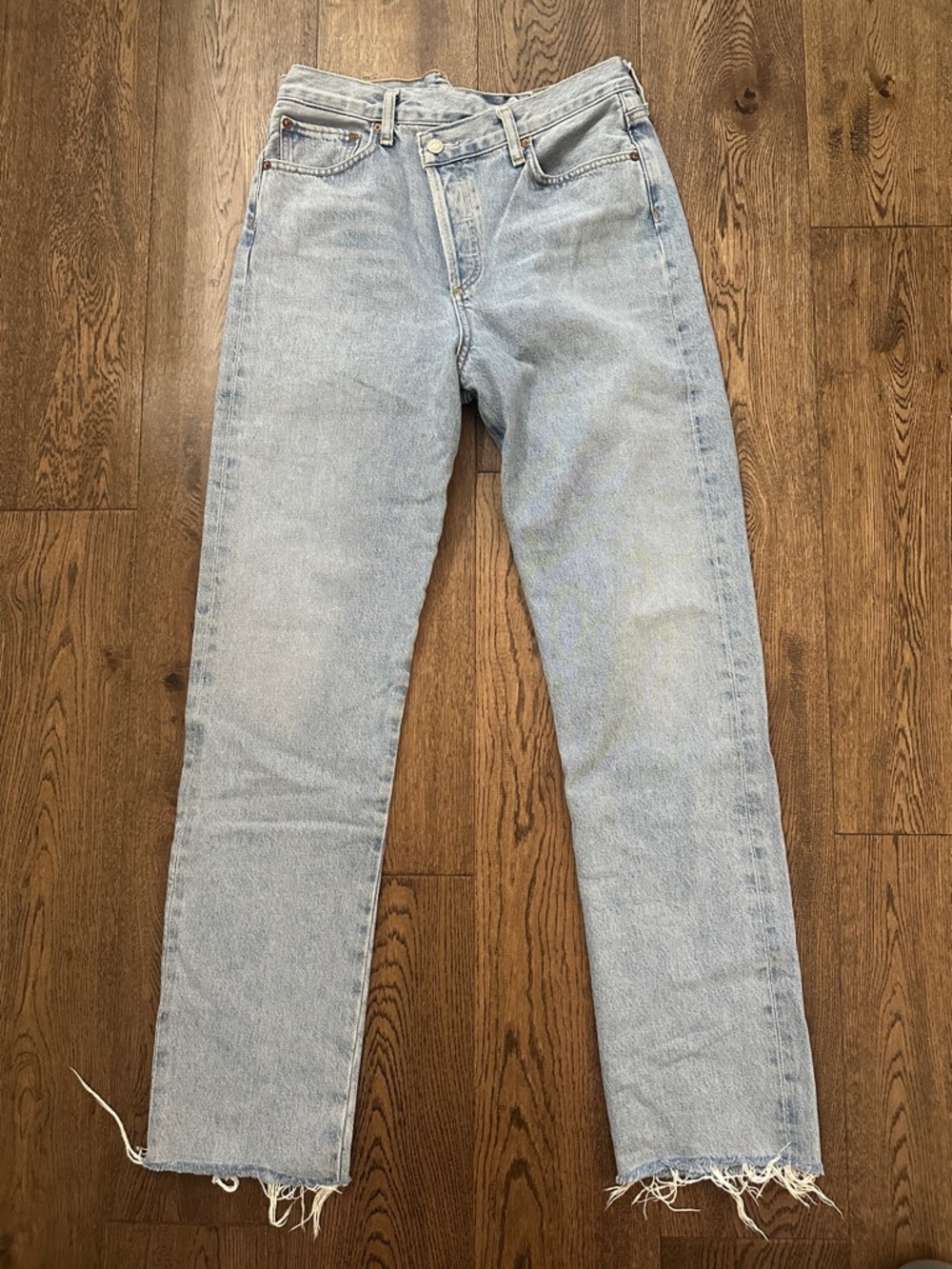 Agolde High Rise Straight Leg Jeans in Light Wash Blue. Raw hem.